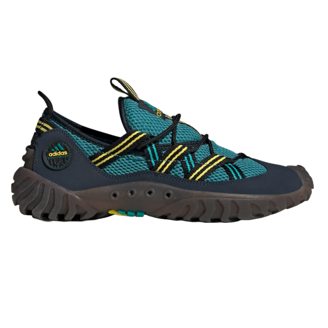 Adidas outdoor shoe with a rugged sole, teal mesh upper, and yellow accents, designed for durability and grip.
