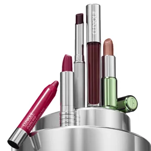 A collection of Clinique lip products in various shades, including lipstick, chubby stick, and gloss, displayed in a sleek silver container.