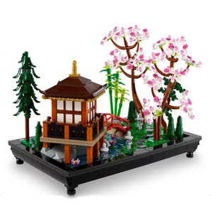 A LEGO set depicting a traditional Japanese garden with a pagoda, bridge, cherry blossoms, and bamboo.