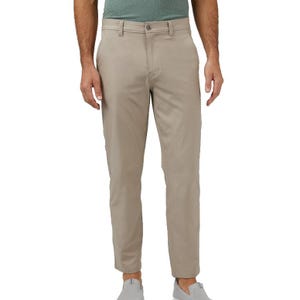 Men's beige pants with a button and zip closure, belt loops, and side pockets, paired with a green shirt and gray slip-on shoes.
