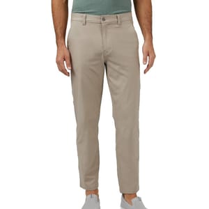 Men's beige pants with a button and zip closure, belt loops, and side pockets, paired with a green shirt and gray slip-on shoes.