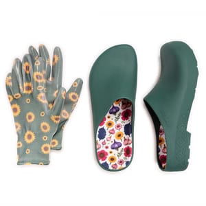 A pair of green gardening clogs with a floral-patterned insole is displayed alongside sunflower-patterned gardening gloves.