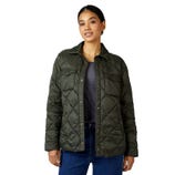 A woman is wearing an olive green quilted jacket with button closures, two chest pockets, and a shirt collar. She pairs it with a gray top and blue jeans.