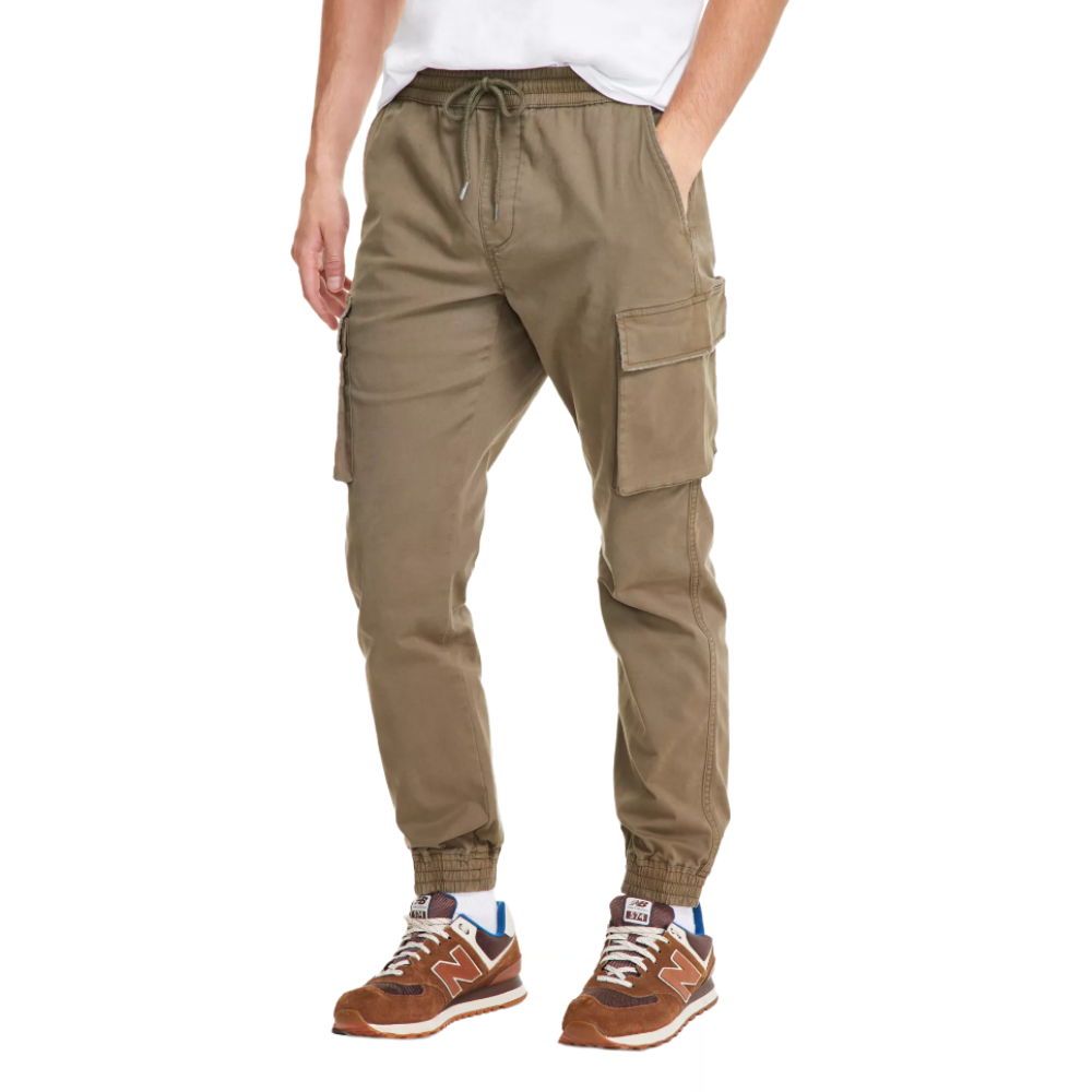 Khaki cargo jogger pants with an elastic waistband and drawstring, featuring large side pockets. Paired with brown sneakers.