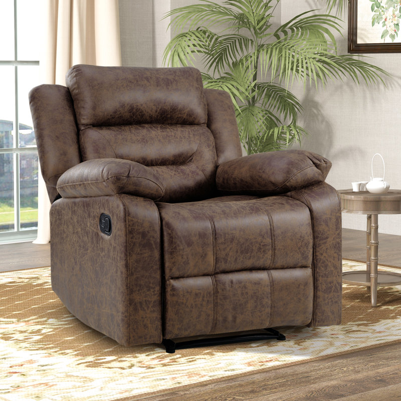 Brown leather recliner chair with plush armrests and a manual control on the side, situated in a living room setting.