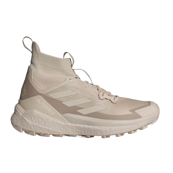 A beige Adidas Terrex Hiker 2.0 shoe with a high-top design, featuring a sock-like upper, lace-up closure, and textured sole for grip. The shoe displays the Adidas logo and branding, providing a sleek and minimalist style.