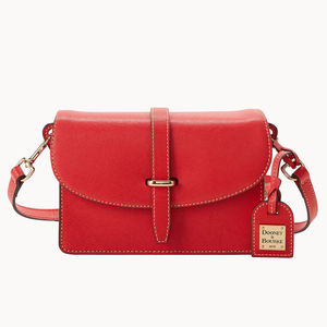 A red Saffiano leather crossbody bag with a front flap closure, a buckle detail, an adjustable strap, and a branded luggage tag.