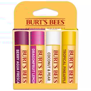 Burt's Bees Tropical Lip Balm 4-pack includes flavors: Berry Agua Fresca, Dragonfruit Lemon, Coconut & Pear, and Tropical Pineapple. Each tube's design features a color-coded cap reflecting its flavor, packed in a yellow carton.