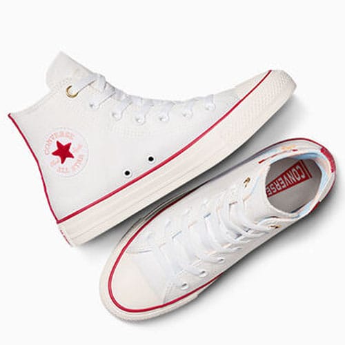 A pair of white high-top Converse sneakers with red and blue trim.