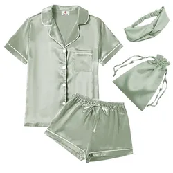 A sage green satin sleepwear set including a short-sleeve button-up top, shorts, an eye mask, and a drawstring bag.