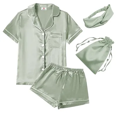 A sage green satin sleepwear set including a short-sleeve button-up top, shorts, an eye mask, and a drawstring bag.