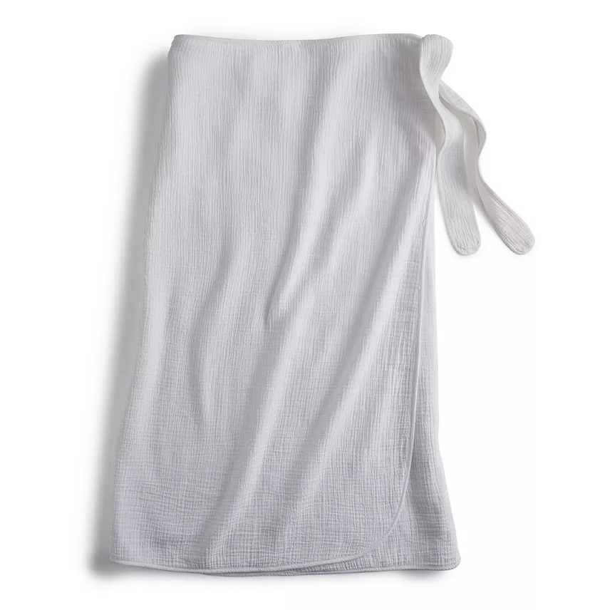 White cotton gauze bath wrap with a textured surface and tie closure, designed for post-bath use.