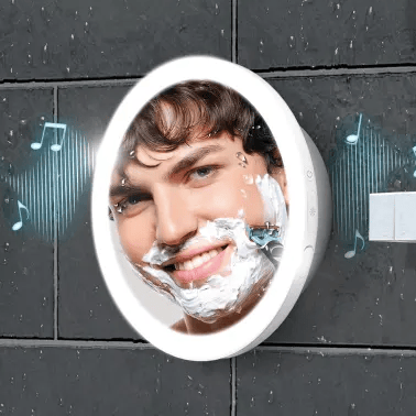 A waterproof shower mirror with integrated Bluetooth speakers, shown mounted on a tiled bathroom wall, with musical notes indicating sound playing.