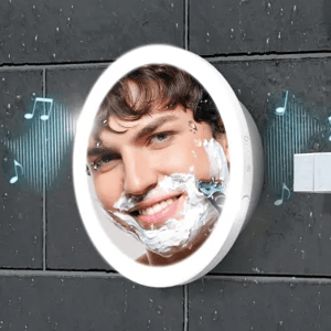 A waterproof shower mirror with integrated Bluetooth speakers, shown mounted on a tiled bathroom wall, with musical notes indicating sound playing.