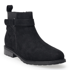 A black suede ankle boot with a strap detail, featuring a low block heel and a pull tab at the back.