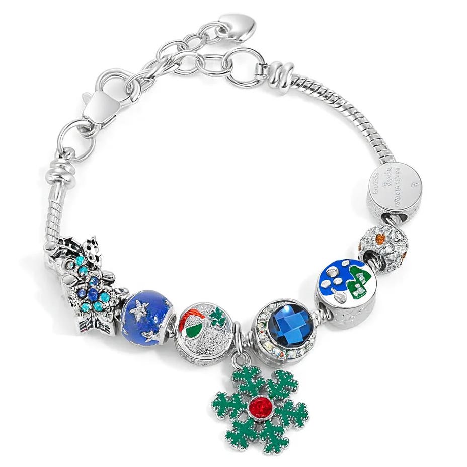A silver charm bracelet featuring a variety of colorful charms, including a green snowflake with a red center, blue and green beads, and ornaments with small crystals.