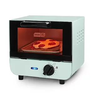 A mint green Dash toaster oven with a glass door, containing a pizza, has a logo on the front, a temperature dial on the right, and a timer knob below the door.