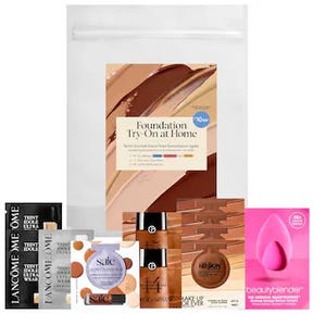 A variety of foundation samples alongside a pink beauty blender sponge.