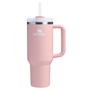 A pink 40oz Stanley Quencher tumbler with a handle, featuring a wide mouth and a straw lid. The design includes a stainless steel band near the top and a brand logo.
