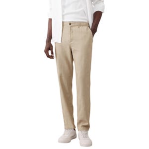 Men’s beige linen-blend pants with a straight fit, featuring a button closure and paired with white casual shoes.