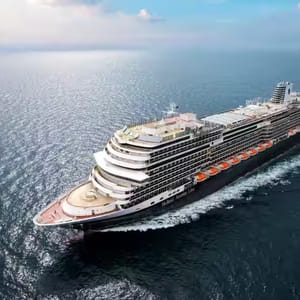 A large cruise ship from Holland America Line sailing on the ocean.