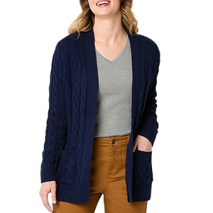 The St. John's Bay Women's Cardigan is a navy, cable-knit open-front sweater with long sleeves and front pockets, paired with a gray v-neck shirt and brown pants.