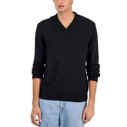 A person is wearing a dark long-sleeve sweater with a V-neck and light blue jeans.