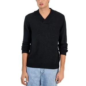 A person is wearing a dark long-sleeve sweater with a V-neck and light blue jeans.
