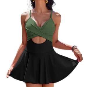A two-tone swimsuit dress featuring a green twisted halter top and a black high-waisted skirt with a small front cutout below the bust, creating a flattering silhouette.