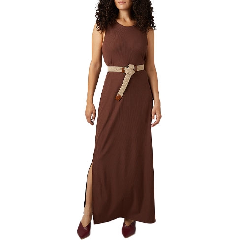 A woman wearing a sleeveless brown maxi dress with a side slit, accessorized with a beige knotted belt and maroon shoes.
