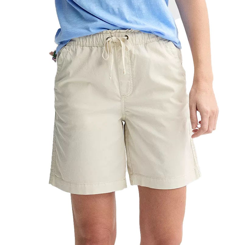 Light beige Bermuda shorts with a paperbag waist, featuring an elastic waistband and drawstring for adjustment. Made from lightweight fabric for casual and comfortable wear.
