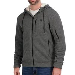 A gray zip-up hoodie with a textured fabric, featuring black drawstrings and various zippered pockets, worn over a white T-shirt and jeans.