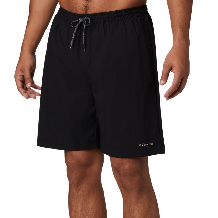 A person wearing plain black swim shorts with a drawstring waist.