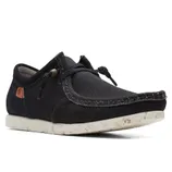 A black casual canvas shoe with a slip-on design, featuring a speckled white sole and side lace details.