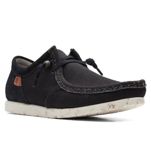 A black casual canvas shoe with a slip-on design, featuring a speckled white sole and side lace details.