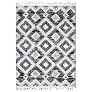 A black and white geometric patterned rug with diamond shapes and fringe along the edges.