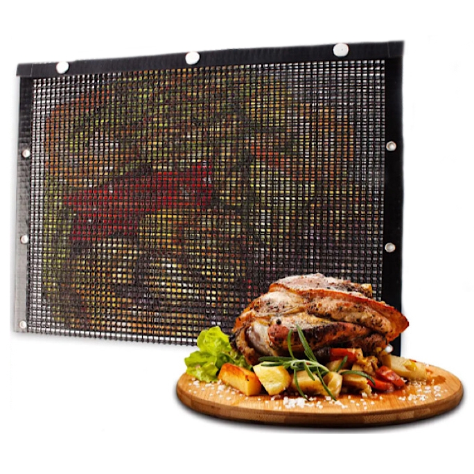 Mesh grill mat with metal grommets, alongside a serving of roasted meat and vegetables on a wooden board.