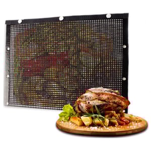 Mesh grill mat with metal grommets, alongside a serving of roasted meat and vegetables on a wooden board.