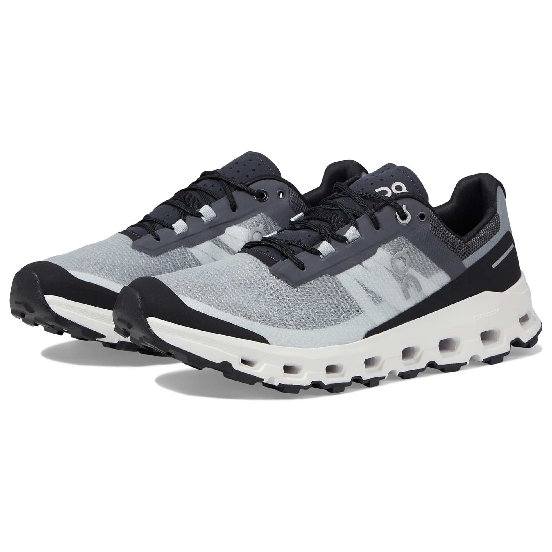 A pair of grey and black sneakers with a white sole and lacing system on top.