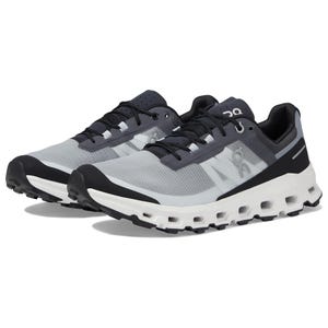 A pair of grey and black sneakers with a white sole and lacing system on top.