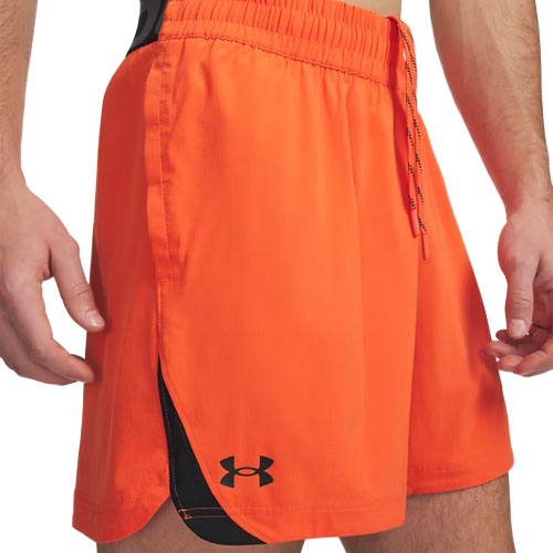 Bright orange athletic shorts with a black Under Armour logo near the hem, featuring an elastic waistband and drawstrings.