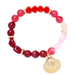 A vibrant beaded bracelet featuring red and pink beads, gold spacers, and adorned with a gold shell charm.