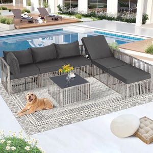 The 7pc Modular Patio Sectional Set features gray cushions on a metal frame, including a three-seat sofa, chaise lounge, and a square coffee table on a patterned outdoor rug, positioned beside a pool.