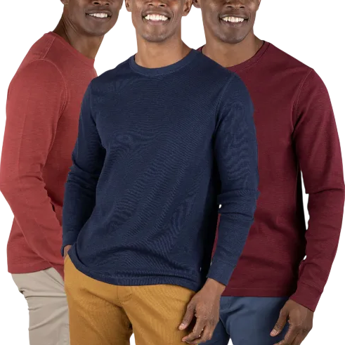 Three men wearing crew neck sweaters in red, navy, and maroon, paired with khaki and blue pants.