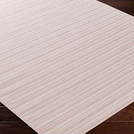 A beige and pink striped area rug on a dark wooden floor.