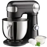 Black stand mixer with a metal mixing bowl, accompanied by two eggs, a small bowl of flour, and a mint garnish.