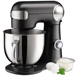 Black stand mixer with a metal mixing bowl, accompanied by two eggs, a small bowl of flour, and a mint garnish.