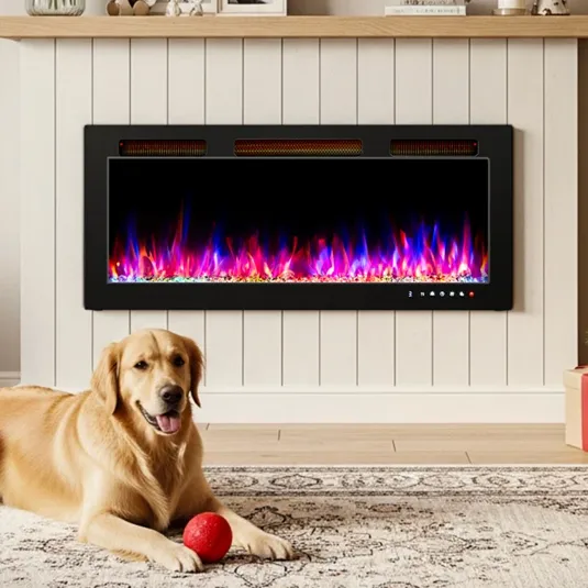 A golden retriever lies on a rug with a red ball near an electric wall-mounted fireplace displaying multicolored flames.