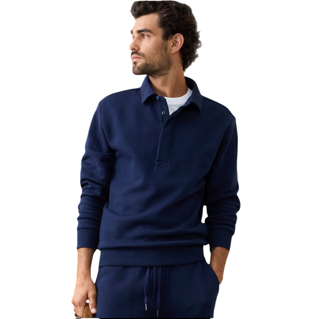 A man is wearing a navy pullover with a collared design and matching drawstring sweatpants.