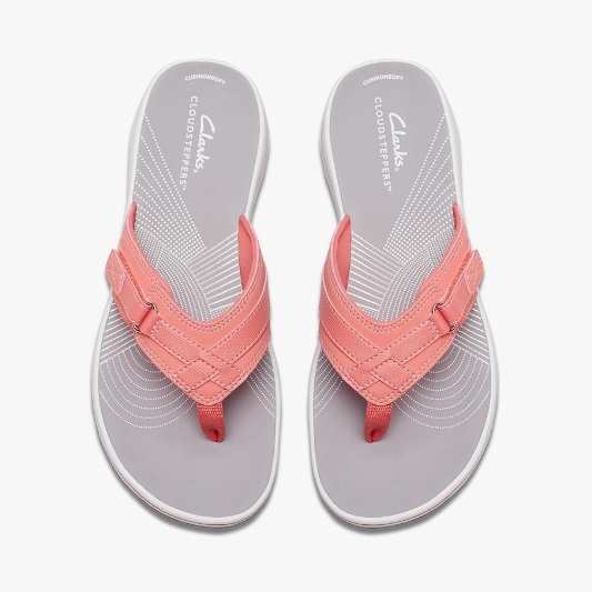 A pair of salmon pink flip-flops with a braided strap design.